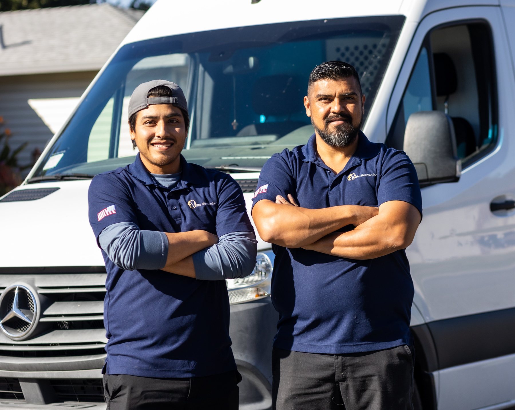 Villa Electric Inc. technicians in front of a work van